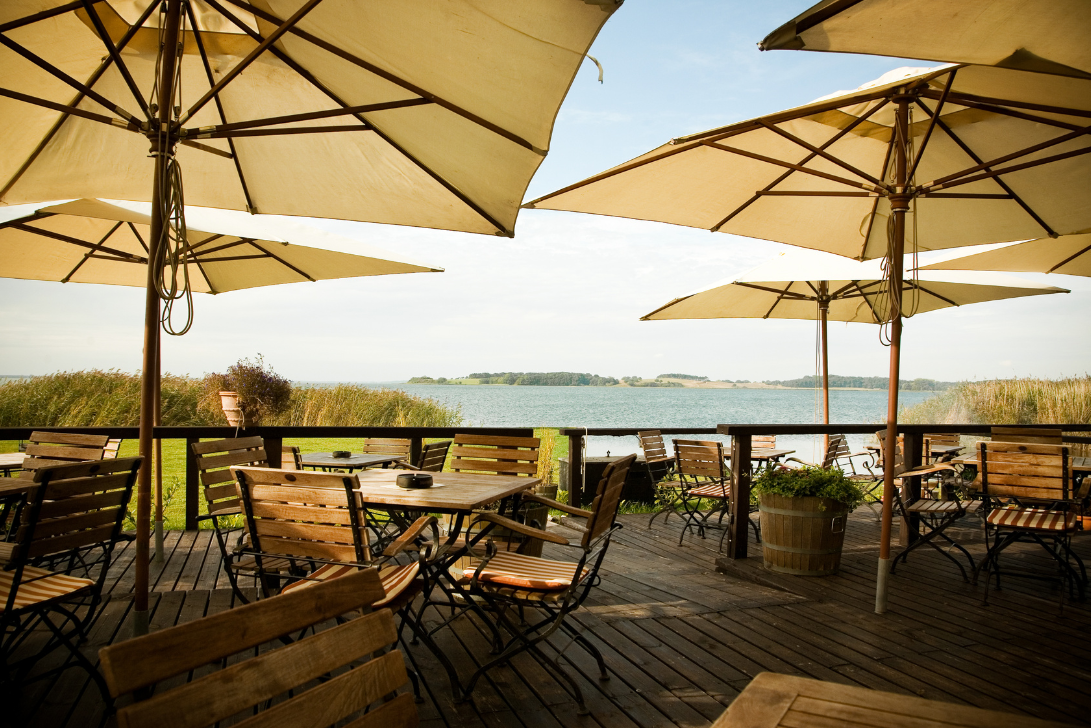Imagen de una terraza en Barcelona, cumpliendo con la normativa y mostrando el diseño adecuado con mesas, sillas y parasoles.